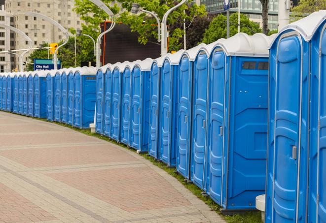 a line of portable restrooms at a sporting event, providing athletes and spectators with clean and accessible facilities in Clay Center, NE